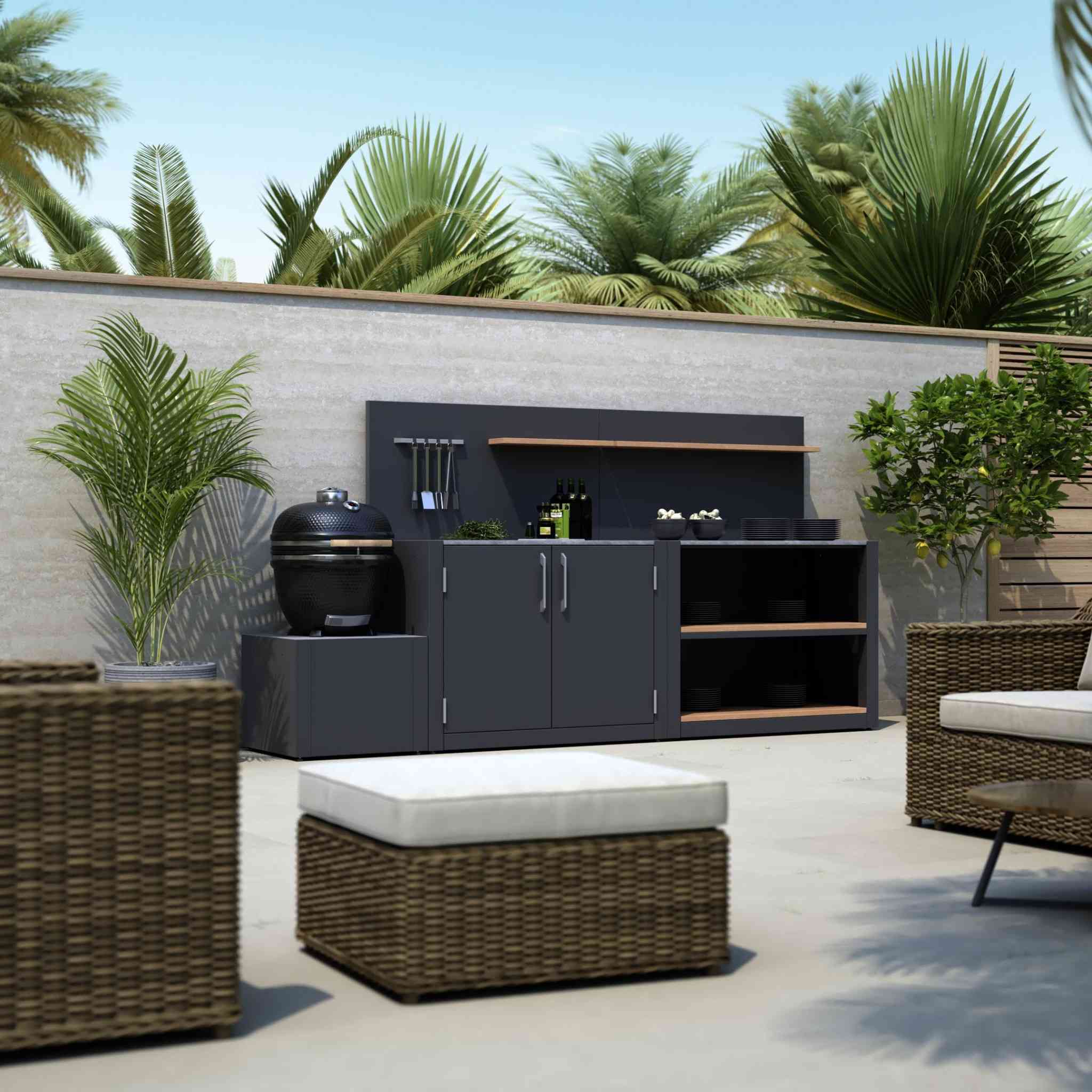 Compact outdoor kitchen with Kamado grill base, cabinet storage and shelving.