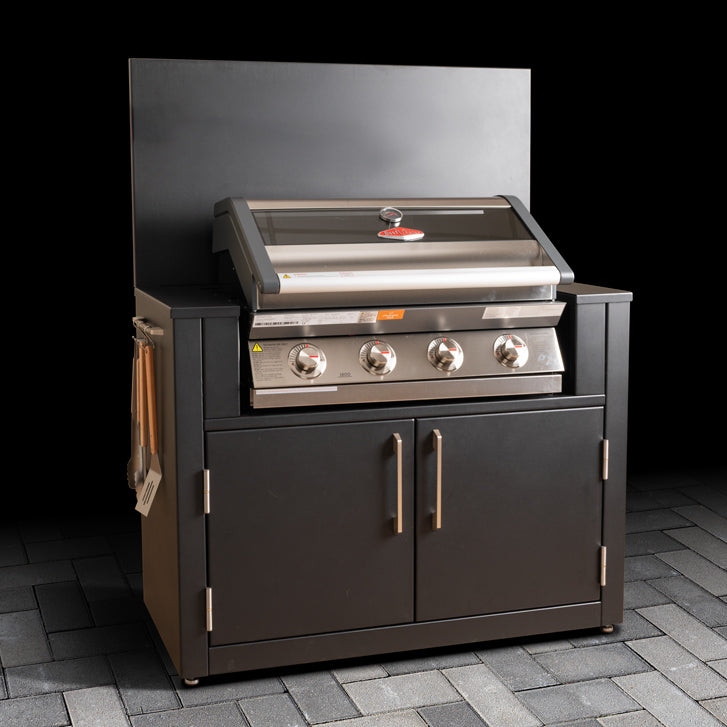 Outdoor BBQ cabinet with stainless steel grill space, double doors, back panel and hanging kitchen accessories.