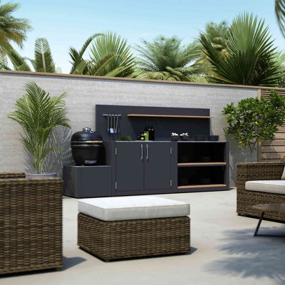 Compact outdoor kitchen with Kamado grill base, cabinet storage and shelving.