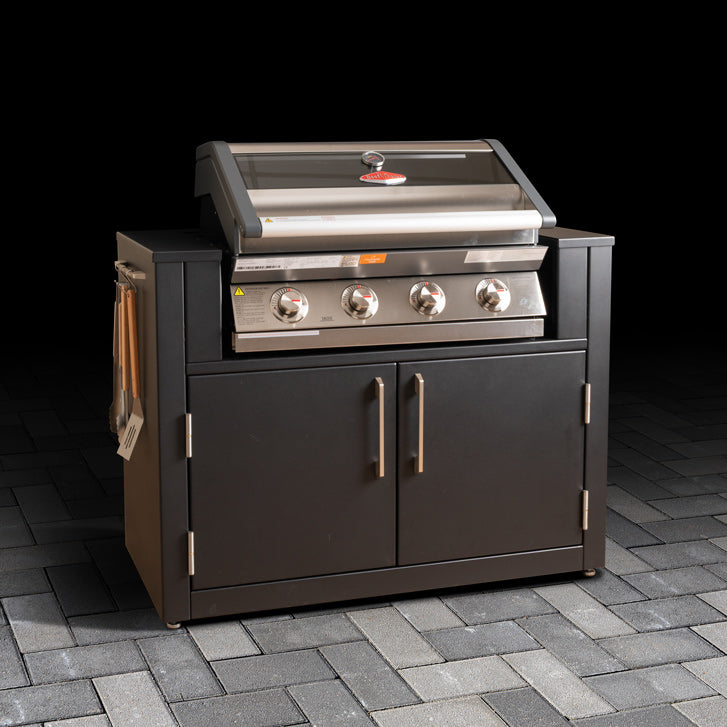 Outdoor BBQ cabinet with stainless steel grill space, double doors and hanging kitchen accessories. 