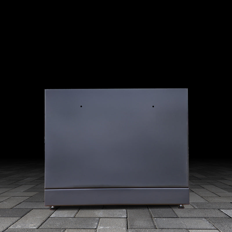 Black outdoor kamado grill base unit on a dark pavement background