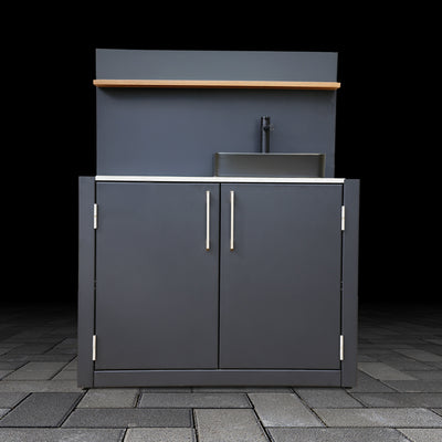 Outdoor kitchen cabinet with sink and countertop on a dark background