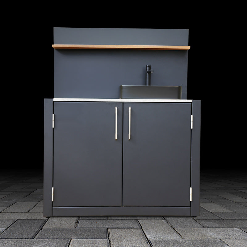 Outdoor kitchen cabinet with sink and countertop on a dark background